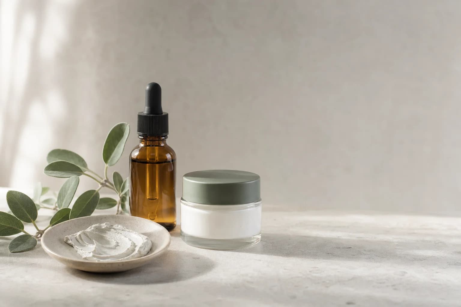Skin care essentials arranged on a stone surface